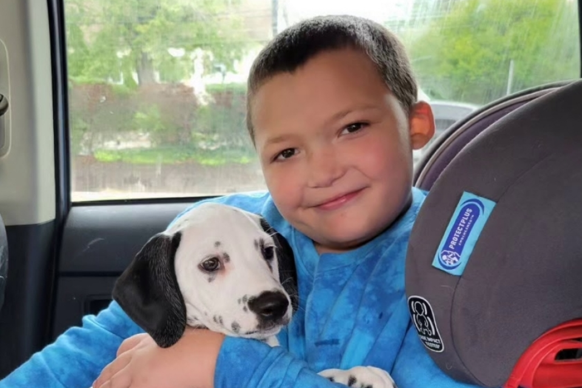Kid holding a dog