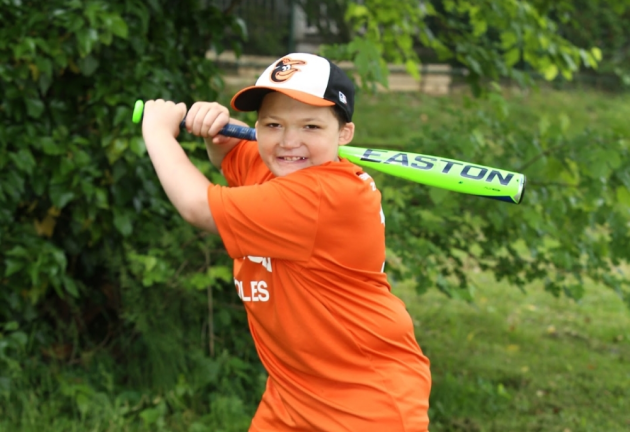 a child holding a baseball bat