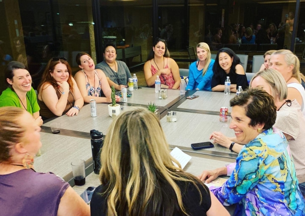 a group of women sitting around a table