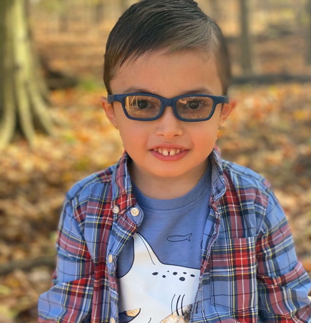 a child wearing glasses and a plaid shirt